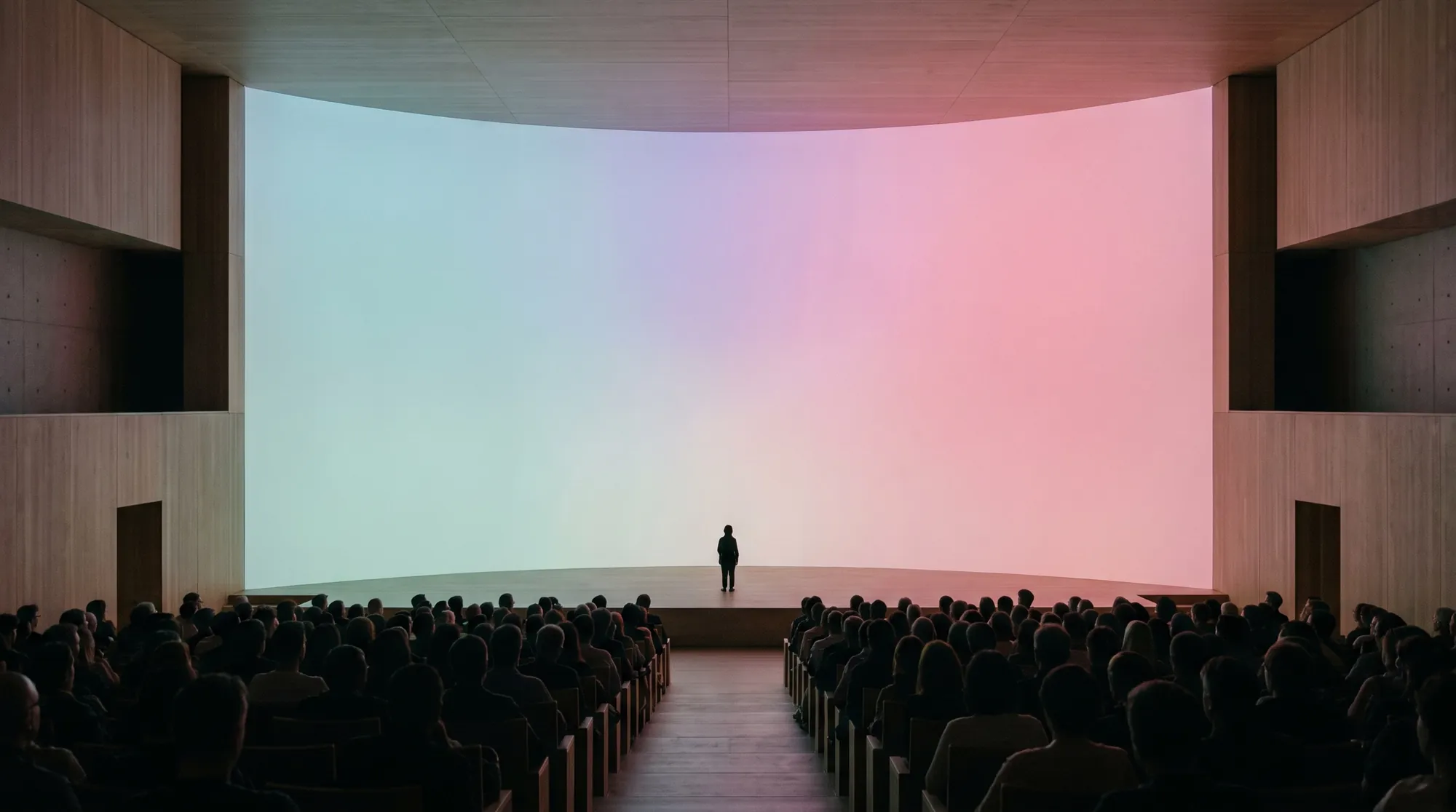 Keynote hall with partner logos on the lit back wall